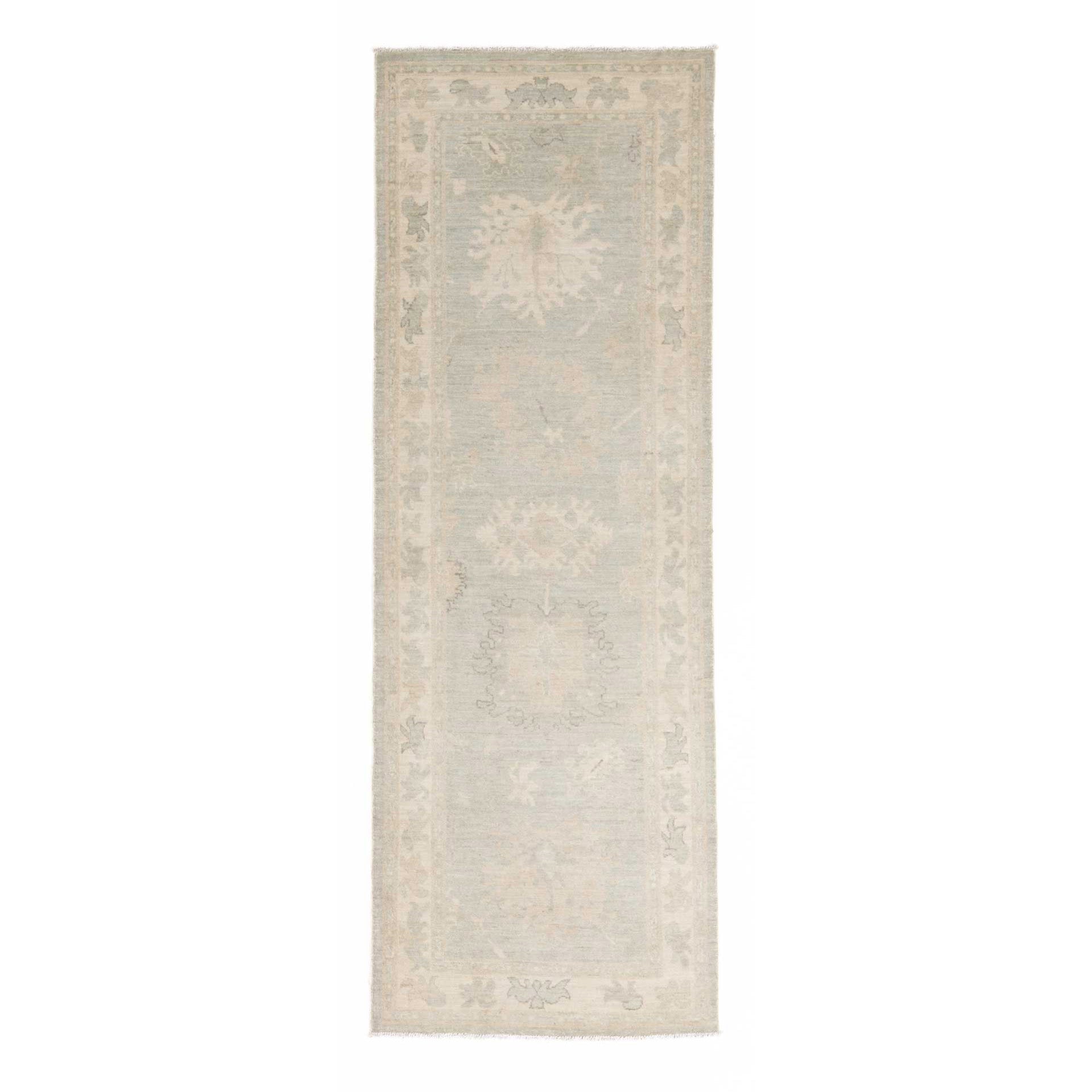 Soft light blue traditional Oushak runner rug with a muted beige and ivory floral border and distressed low pile finish.