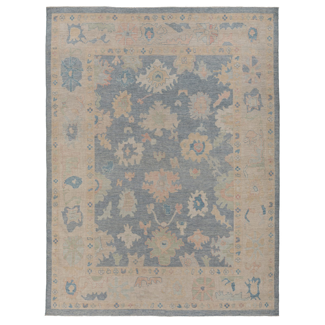 Hand-knotted 9x12 Oushak area rug with a rich slate blue center field, linen beige border, and soft coral accents.