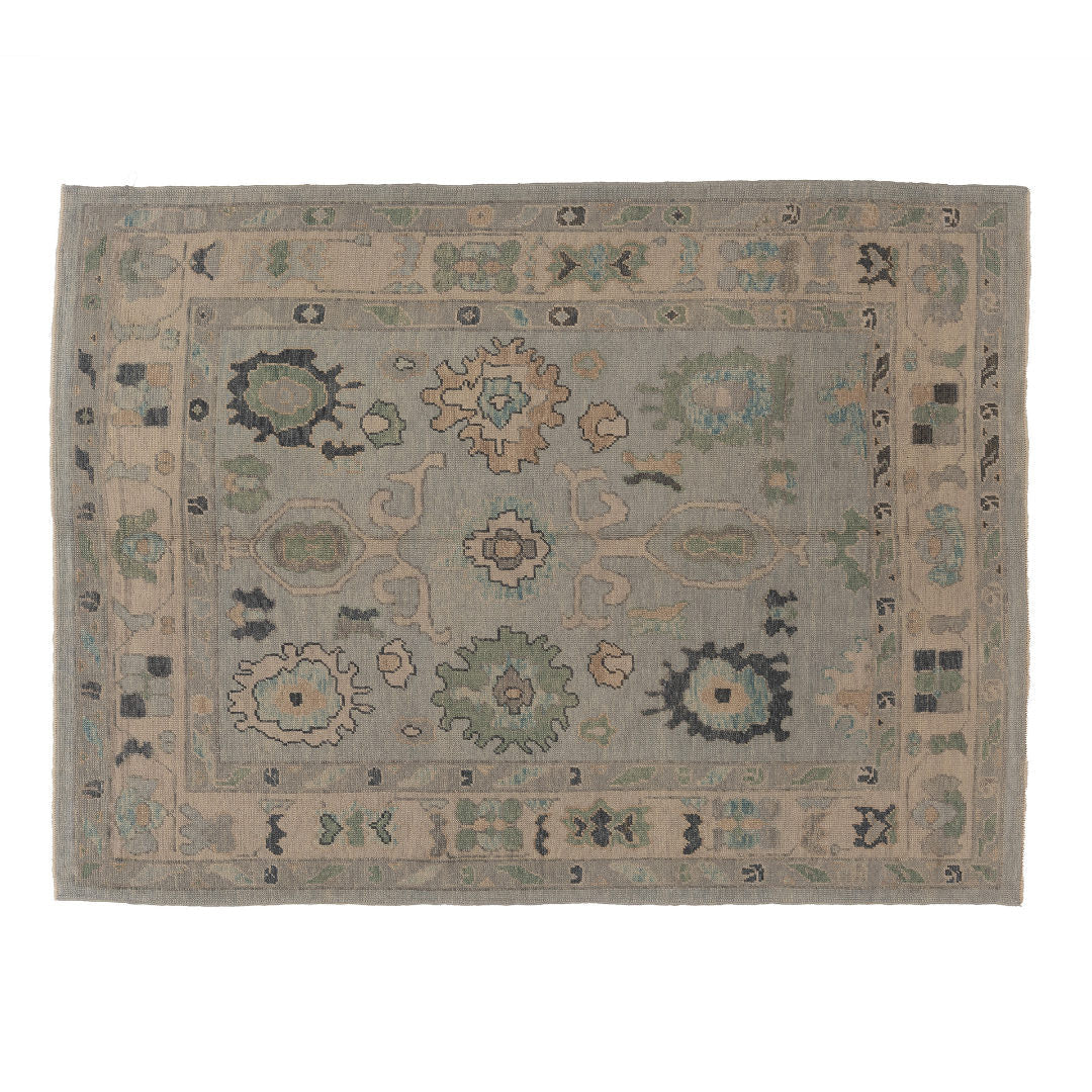 Light blue 6x9 Oushak area rug with sage green and cream scalloped medallions and charcoal accents.