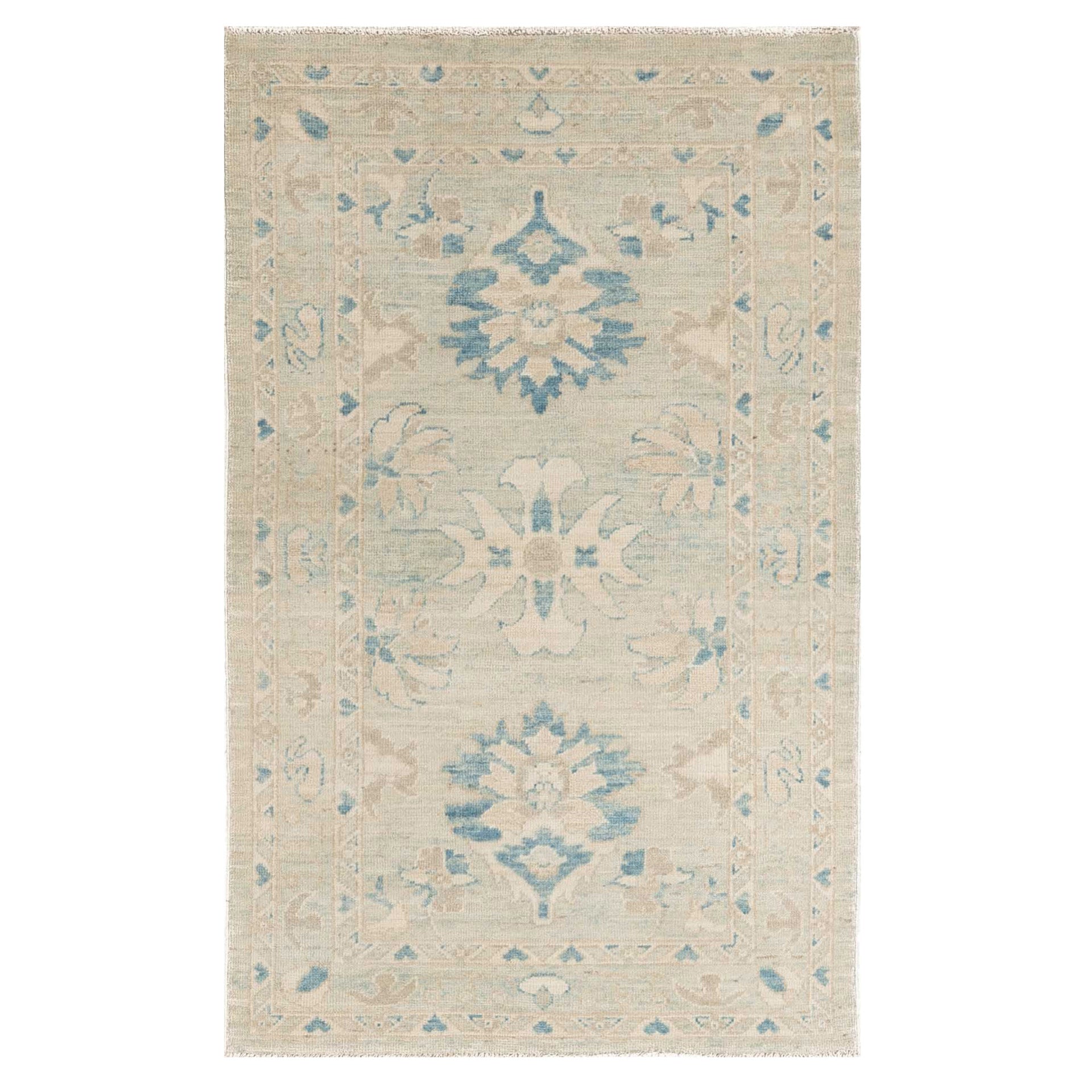 Traditional soft blue 3x5 Oushak area rug with muted ivory borders and dark blue geometric star medallions.
