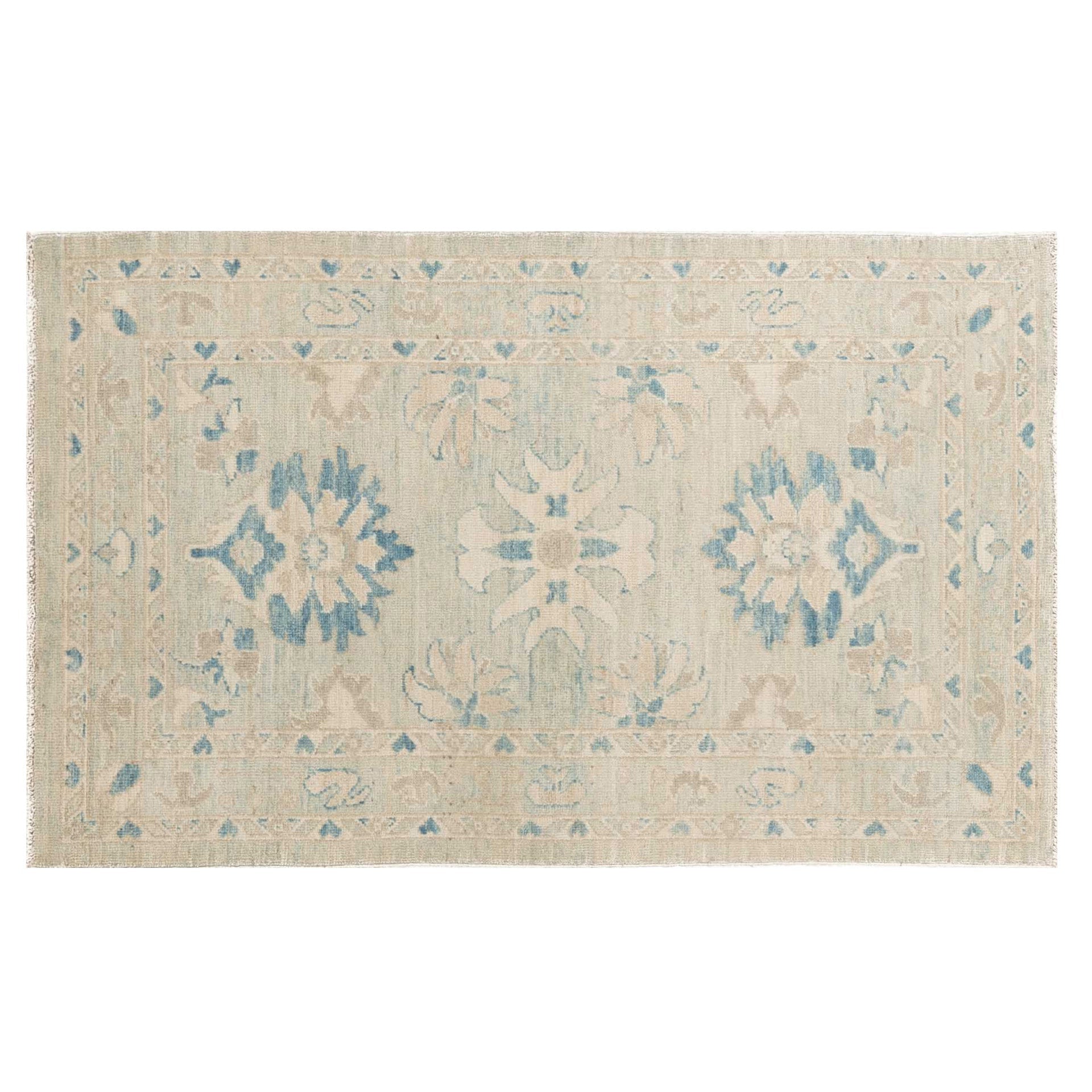 Traditional soft blue 3x5 Oushak area rug with muted ivory borders and dark blue geometric star medallions.