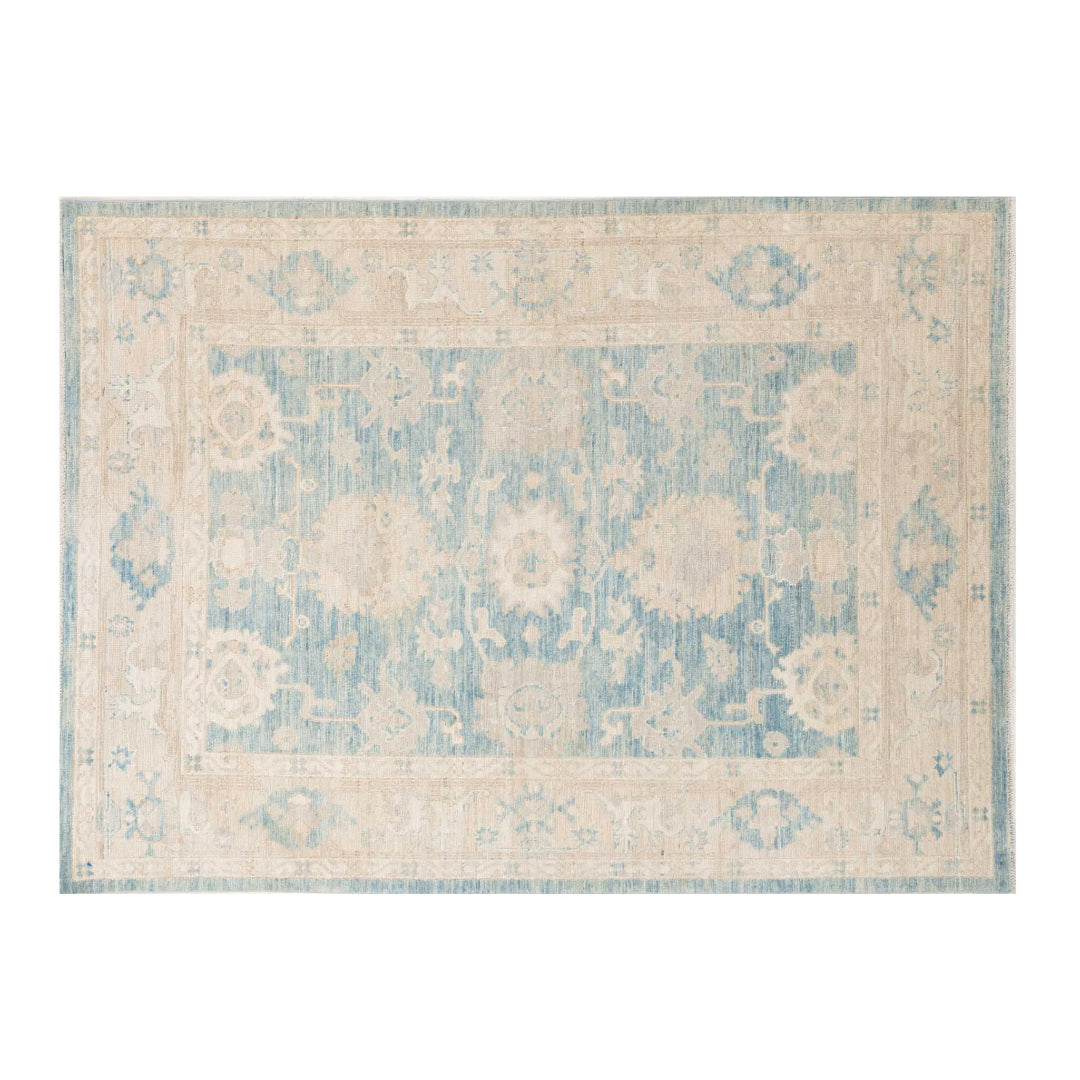 Medium blue 5x7 Oushak area rug with beige central medallion and warm camel vine scrollwork.