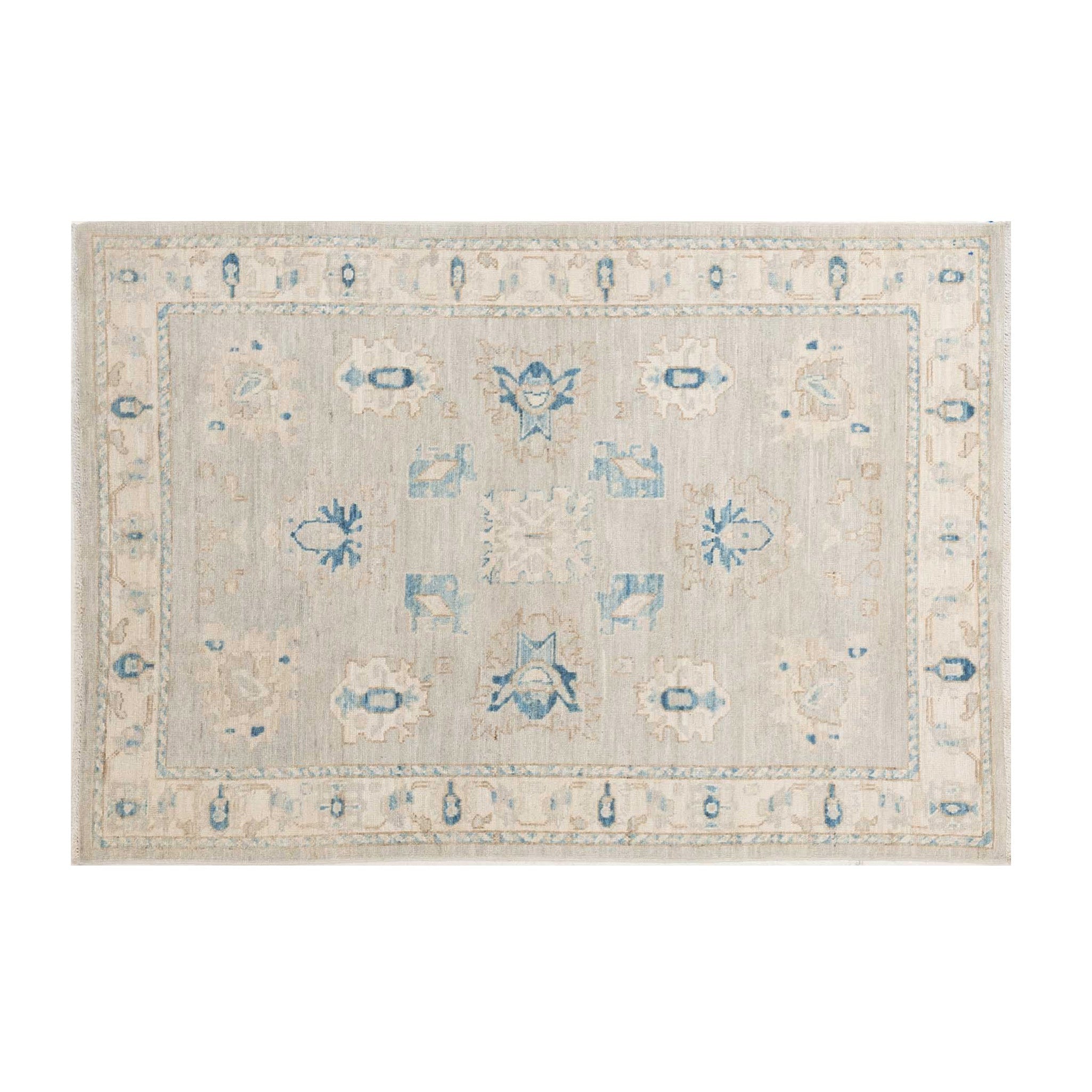Traditional pale blue 4x6 Oushak area rug with muted ivory motifs and prominent dark blue geometric accents.