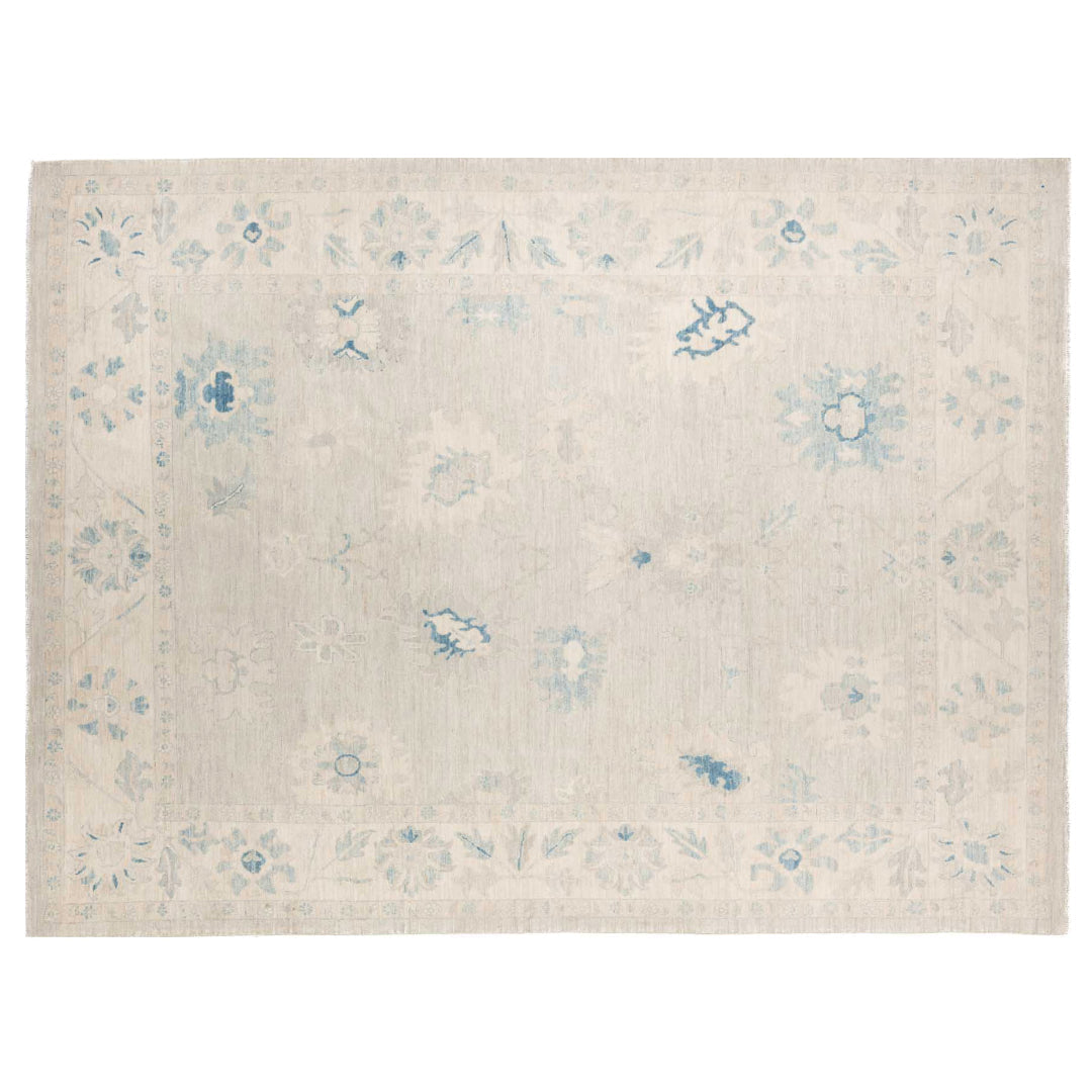 Hand-knotted 9x12 Oushak area rug with a faded sage green field, light blue botanical patterns, and a pale border.