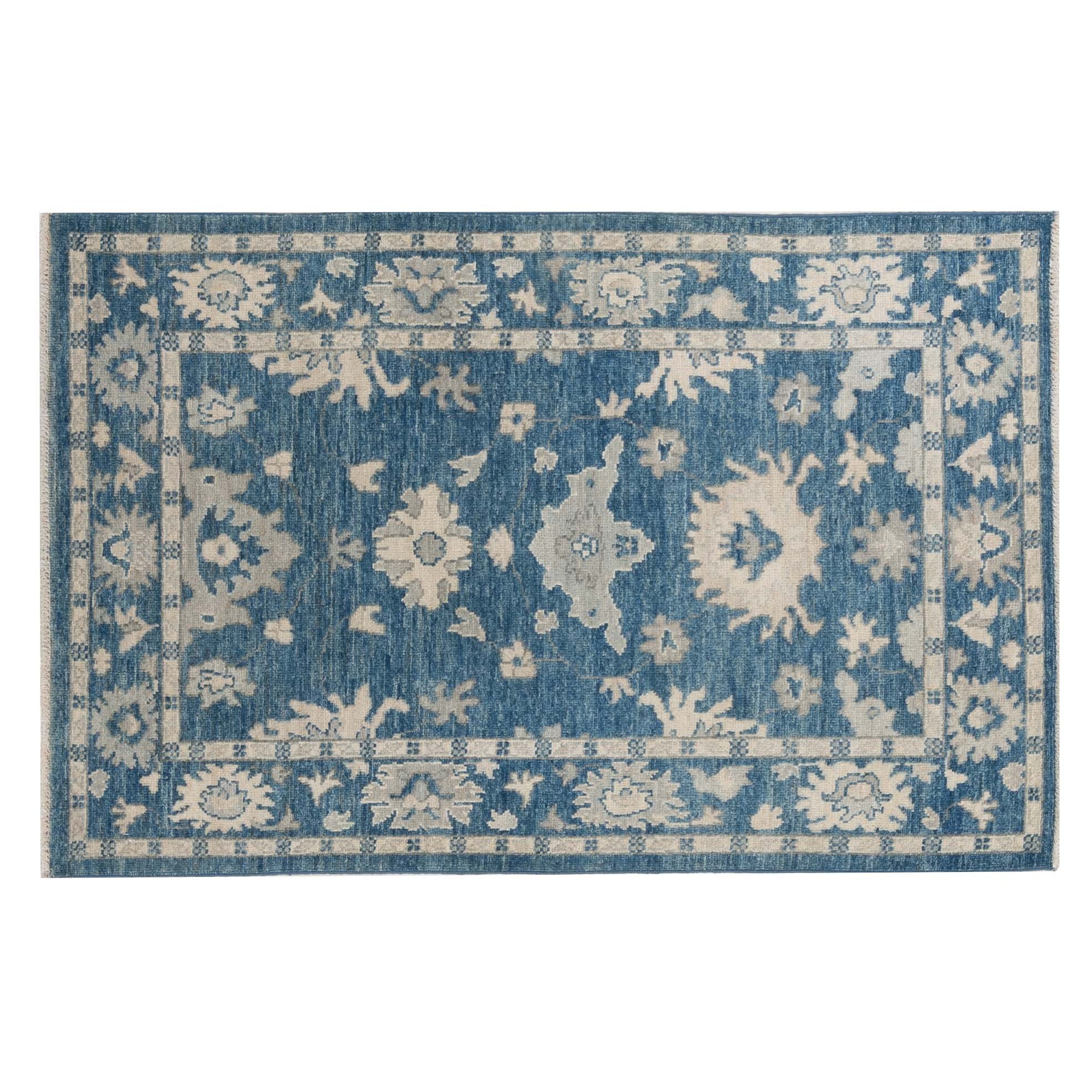 Traditional dark blue 3x5 Oushak area rug with soft ivory and beige geometric medallions and a distressed finish.