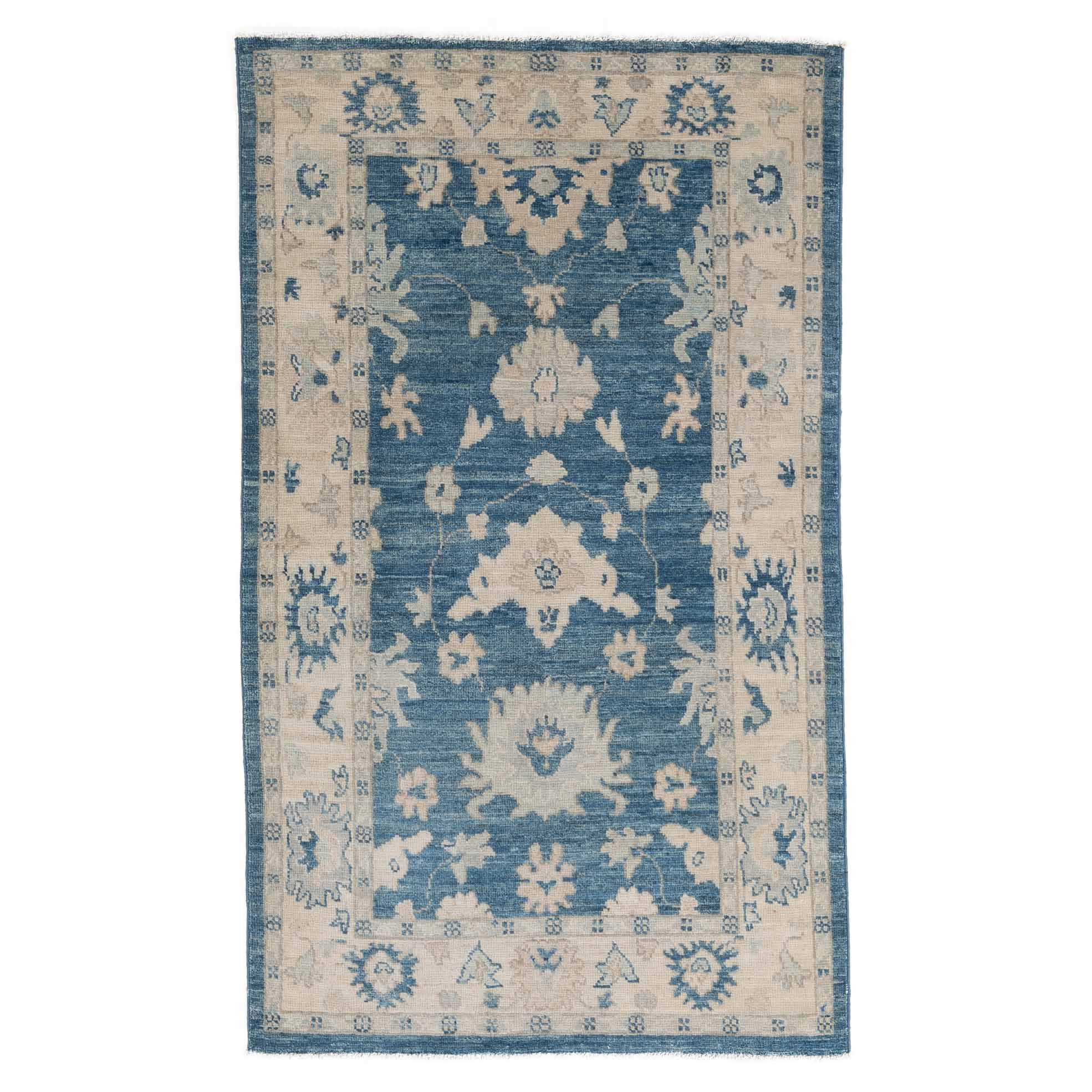 Traditional 3x5 accent area rug with a dark blue central floral design, ivory borders, and a distressed finish.