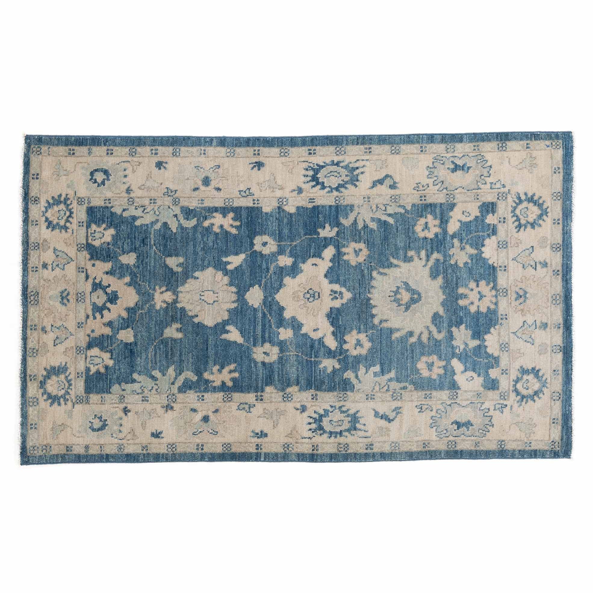 Traditional 3x5 accent area rug with a dark blue central floral design, ivory borders, and a distressed finish.