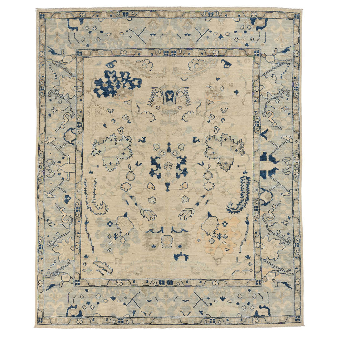Hand-knotted 8x10 Oushak area rug with a bright ivory center field, navy blue floral details, and pale blue border.