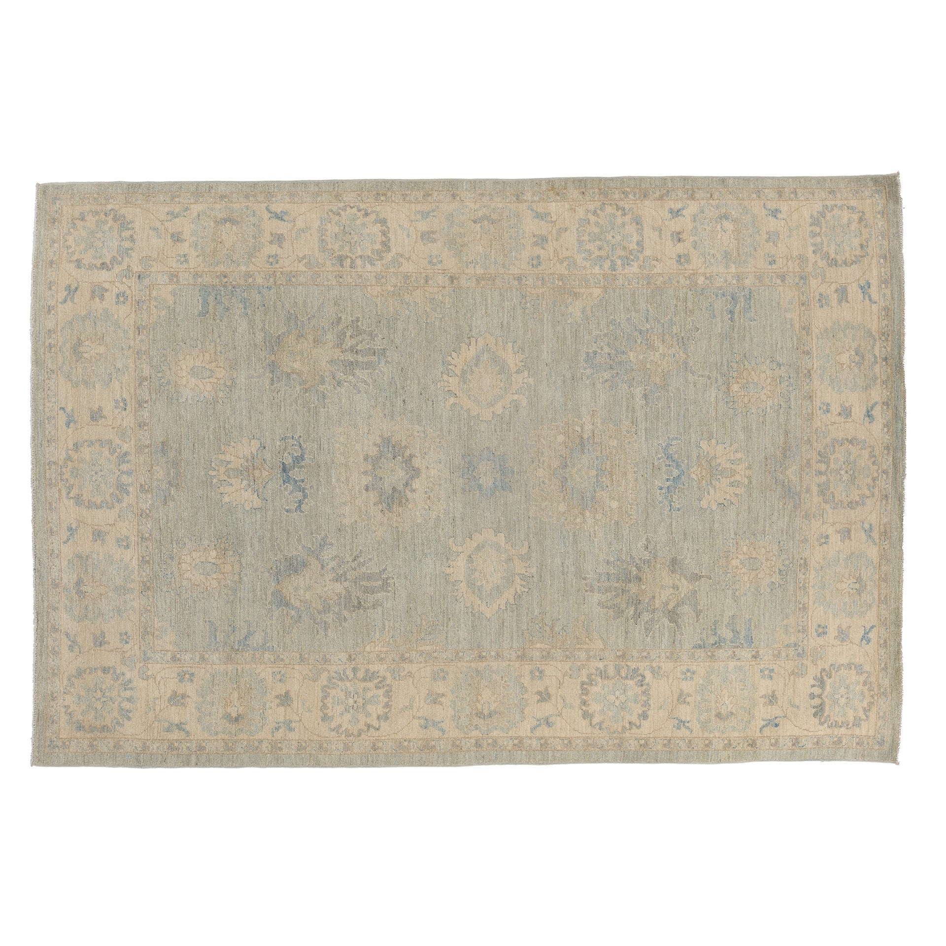 Muted sea foam green 6x9 Oushak area rug with cream floral medallions and a distressed gray-cream border.