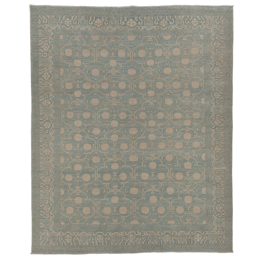 Hand-knotted 8x10 Khotan area rug featuring a muted chambray blue field with an all-over ivory circular lattice design.
