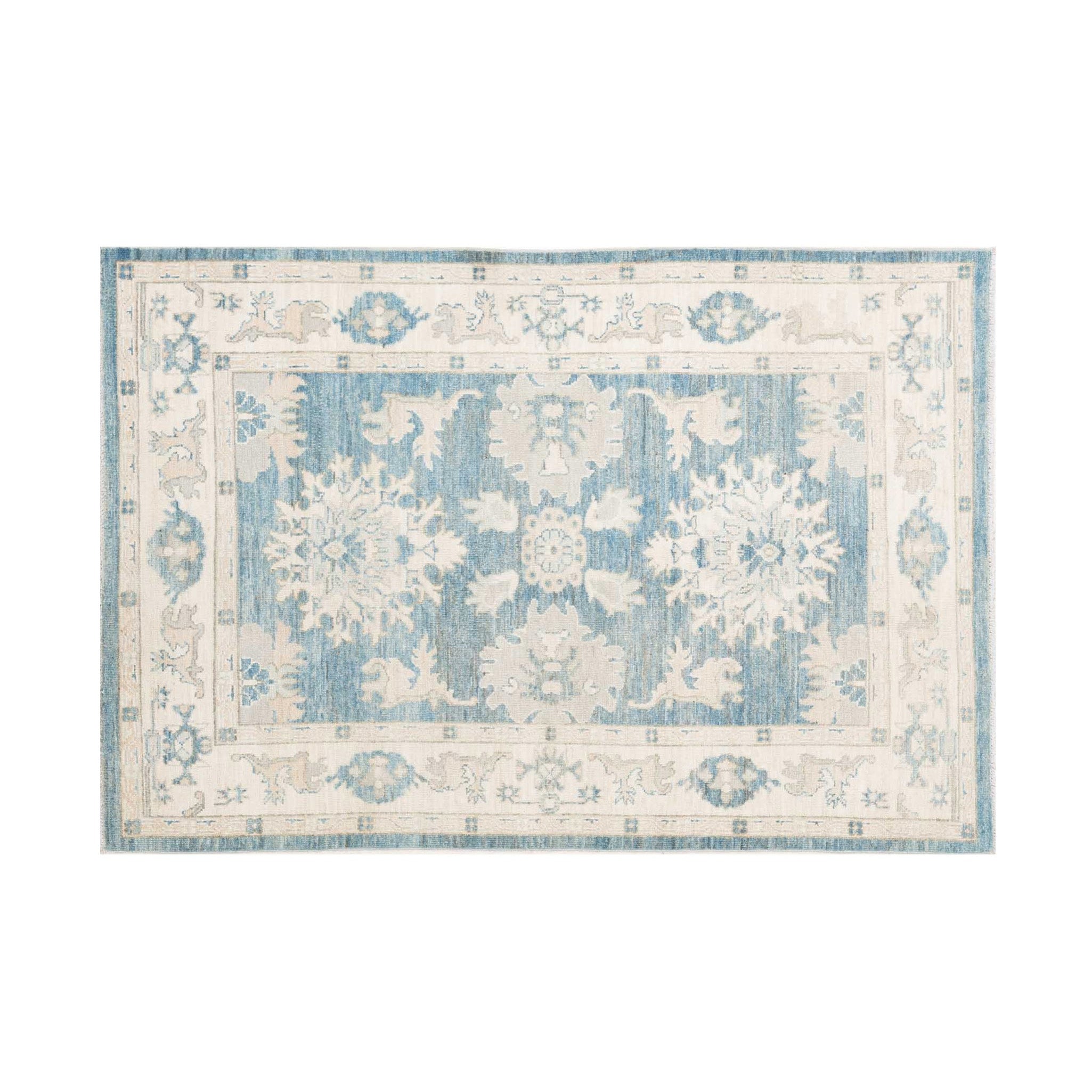 Traditional midnight blue 4x6 Oushak area rug with prominent ivory and beige geometric star medallions and a distressed cream border.