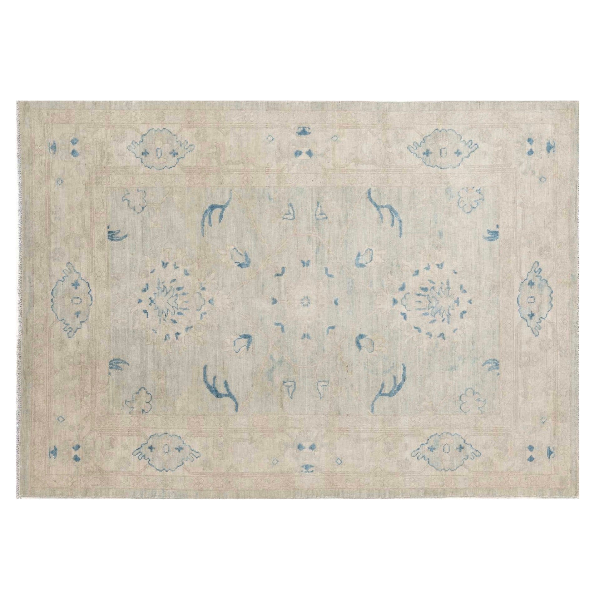 Soft khaki 5x7 Oushak area rug with ivory floral medallions and crisp indigo blue accents.