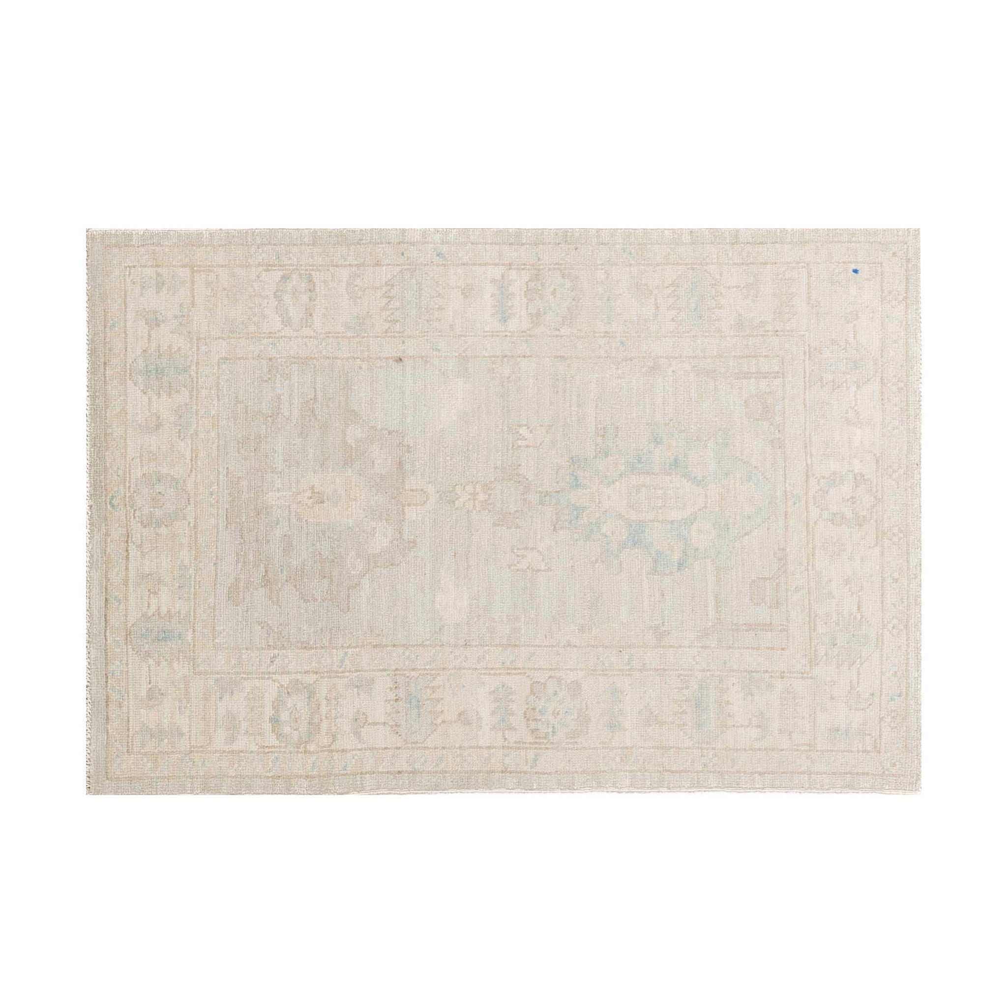 Small cream and light gray 3x4 Oushak accent rug with light blue geometric star medallions and a soft border.