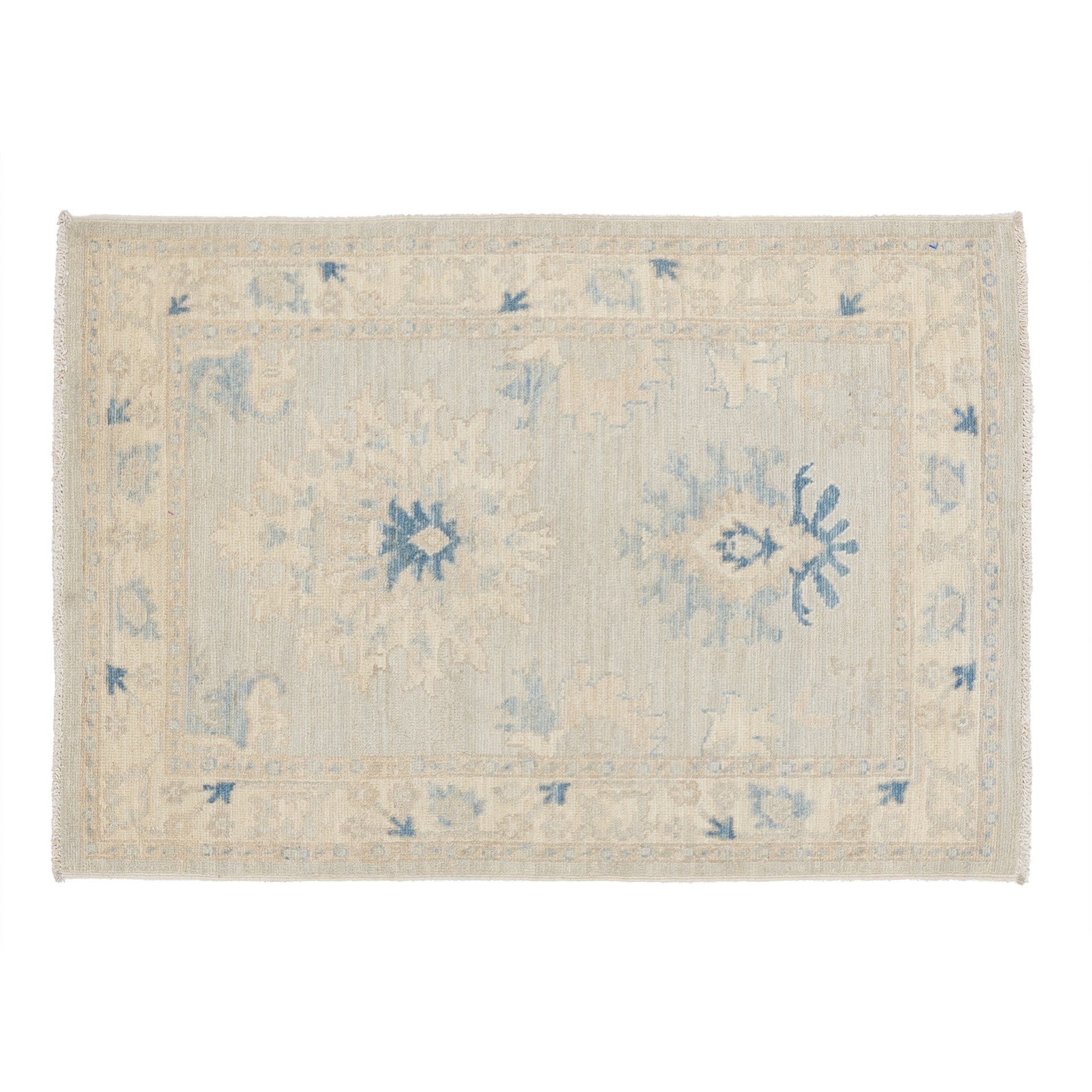 Small pale blue 3x4 Oushak accent rug with cream star medallions and vibrant blue centers.