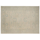Muted beige and gray 10x14 Chobi area rug with soft sea foam blue floral motifs.