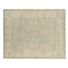 Soft light blue 8x10 Oushak area rug with cream floral medallions and a broad cream border.
