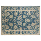 Dark blue 10x14 Oushak area rug with beige floral palmettes and light blue accents.