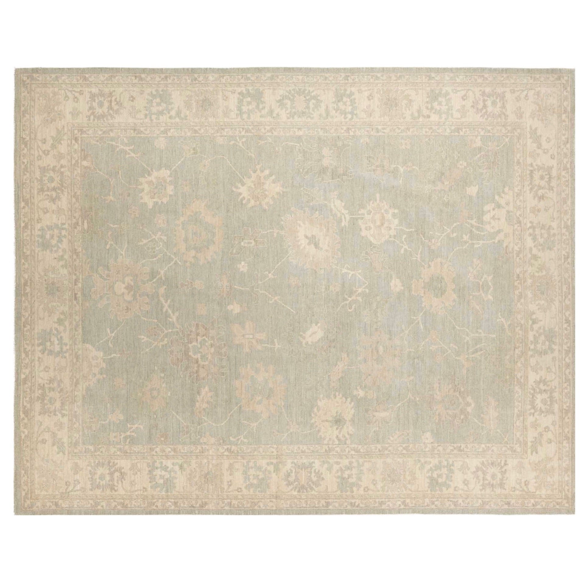 Muted pale blue-gray 9x12 Oushak area rug with cream floral palmettes and a wide cream border.