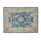 Rich dark blue 5x7 Oushak area rug with cream central medallion and khaki floral accents.