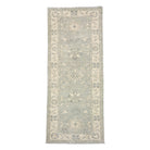 Sage green 2.5x8 Oushak runner rug with ivory floral lotus medallions and a wide cream border.
