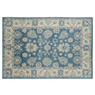 Rich deep blue 6x9 Oushak area rug with cream floral medallions and a wide cream border.