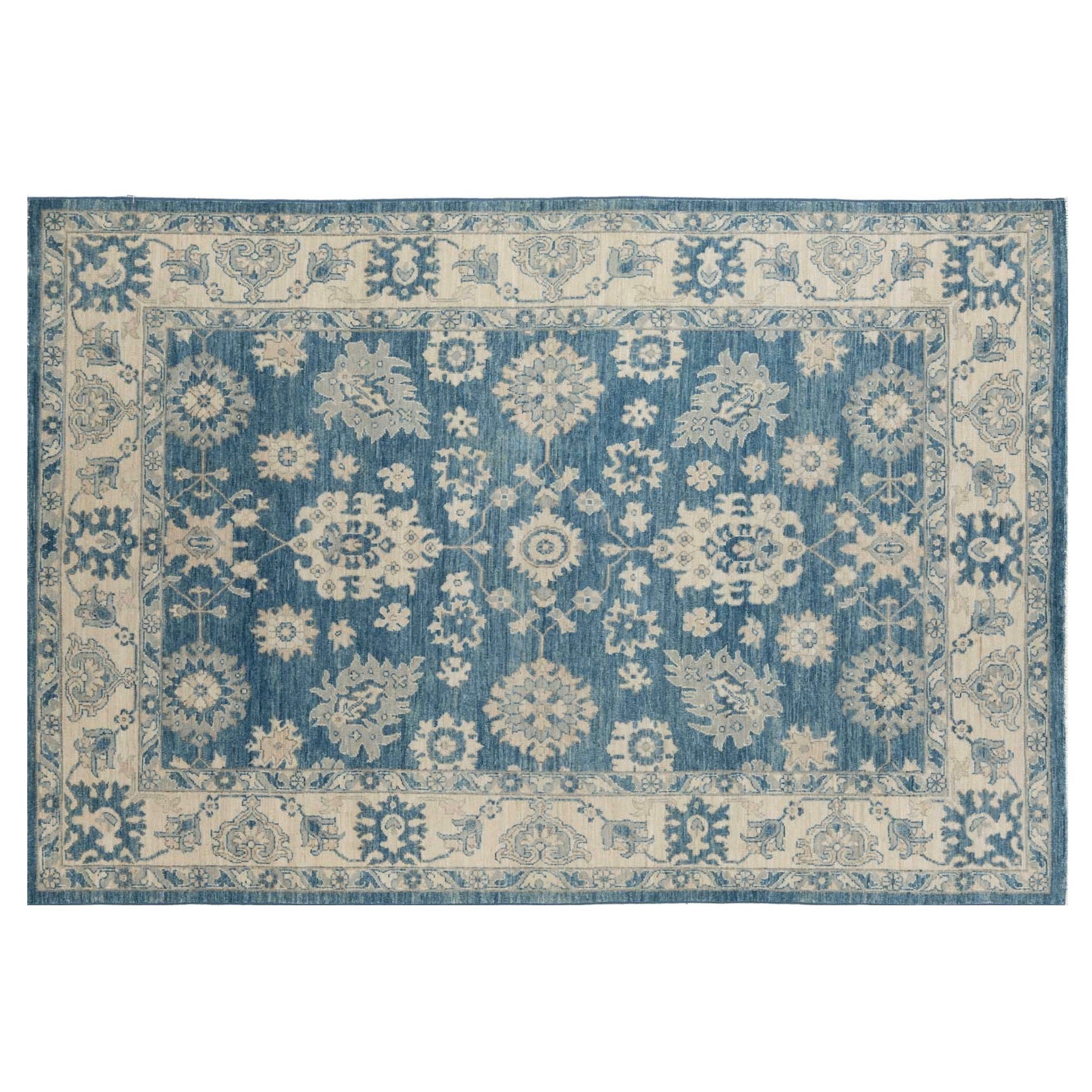 Rich deep blue 6x9 Oushak area rug with cream floral medallions and a wide cream border.