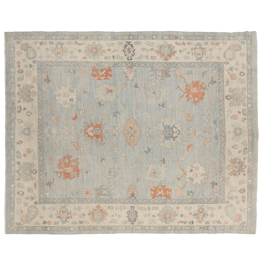 Hand-knotted 9x12 Oushak rug featuring a pale blue field with tangerine orange and cream botanical motifs.
