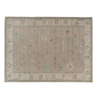 Soft mushroom brown 10x14 Oushak area rug with terracotta and ivory scattered geometric motifs.