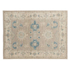Camel tan 4x6 Oushak area rug with ivory floral star medallions, dark blue palmettes, and an ivory border.