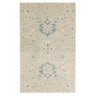 Traditional soft blue 3x5 Oushak area rug with muted ivory borders and dark blue geometric star medallions.