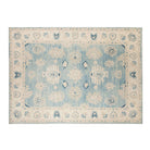Denim blue 10x14 Oushak area rug with strié texture, ivory floral medallions, and navy accents.