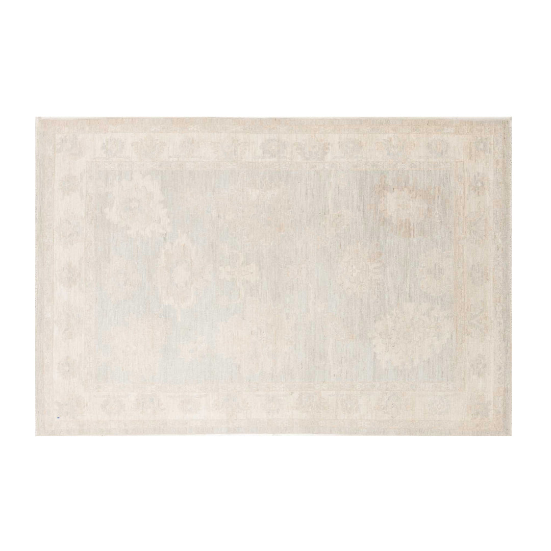Ultra-faded light blue 5x7 Oushak area rug with delicate ivory floral medallions and a warm beige border.