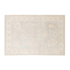 Ultra-faded light blue 5x7 Oushak area rug with delicate ivory floral medallions and a warm beige border.