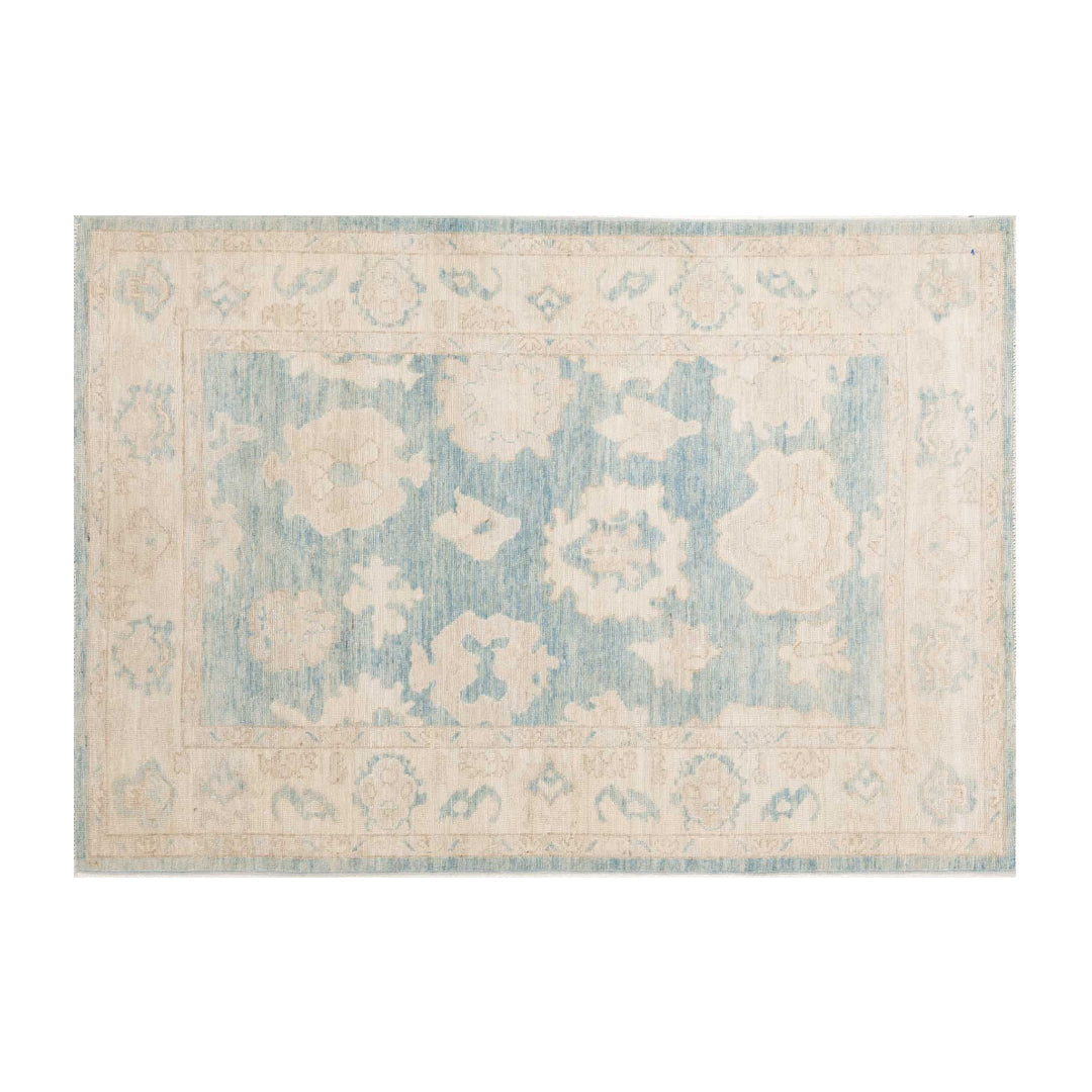 Denim blue 4x6 Oushak area rug with cream floral medallions and a wide ivory border.