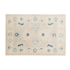 Traditional khaki 4x6 Oushak area rug with soft light blue motifs, contrasting dark blue accents, and a muted ivory border.