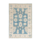 Traditional dark blue 3x5 Oushak area rug with soft ivory and beige geometric medallions and a distressed finish.