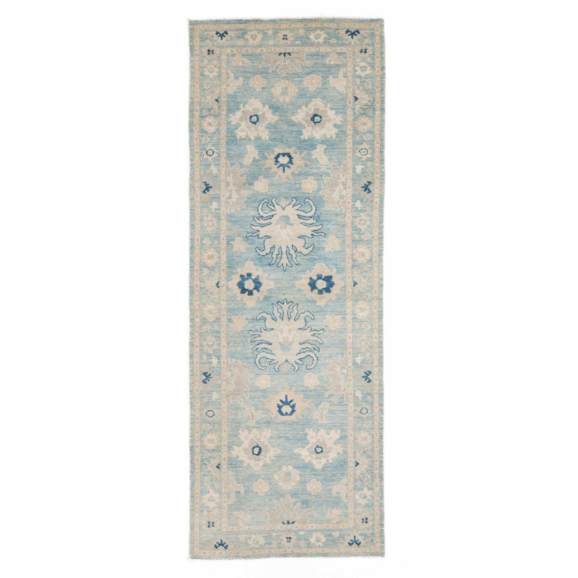 Vibrant medium blue traditional Oushak runner rug with ivory and dark blue geometric star medallions and a cream vine border.