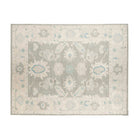 Slate grey 9x12 Oushak area rug with cream floral palmettes and soft blue accents.