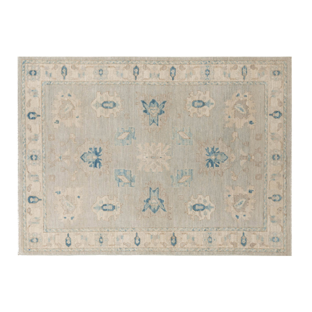 Soft light blue 5x7 Oushak area rug with beige cartouches and sharp dark blue geometric accents.