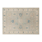 Soft light blue 5x7 Oushak area rug with beige cartouches and sharp dark blue geometric accents.