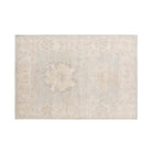 Soft light blue 4x6 Oushak area rug with a muted ivory and mocha floral pattern, cream borders, and a distressed low pile finish.