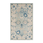 Soft light blue 3x5 Oushak area rug with a muted beige floral pattern, ivory borders, and distressed navy blue accents.