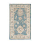 Vibrant medium blue 3x5 Oushak area rug with warm beige and ivory geometric star medallions and a distressed floral border.