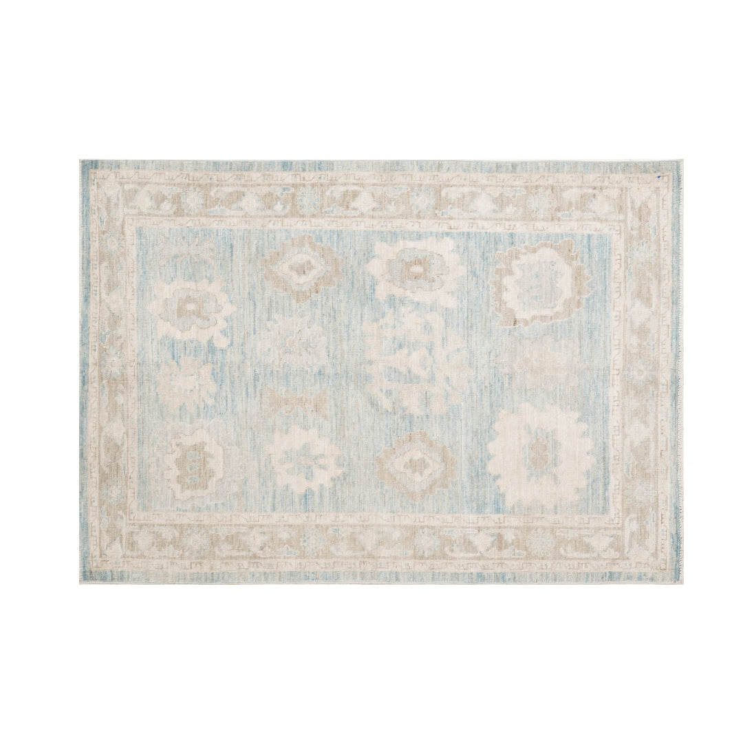 Heathered blue 4x6 Oushak area rug with ivory floral star medallions and mocha brown accents.