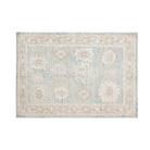 Heathered blue 4x6 Oushak area rug with ivory floral star medallions and mocha brown accents.