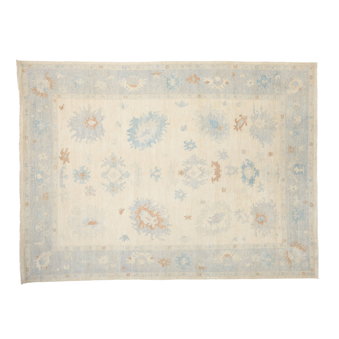 Luminous vanilla 10x14 Oushak area rug with light blue floral cartouches and subtle terracotta accents.
