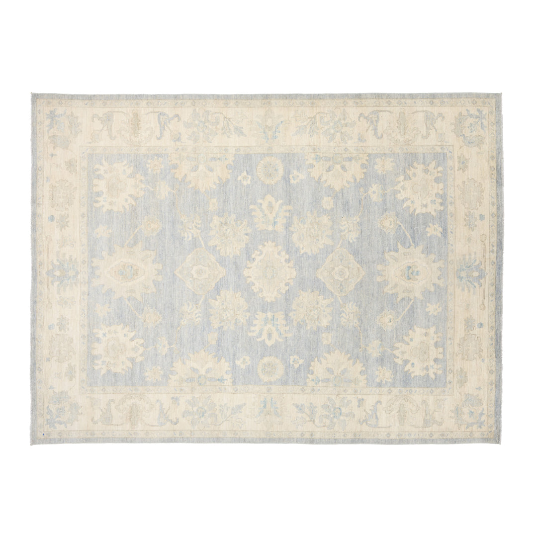 Soft periwinkle blue 9x12 Oushak area rug with ivory floral palmettes and a wide cream border.