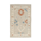 Muted beige 3x5 Oushak area rug with prominent rust and blue geometric floral medallions and a cream border.