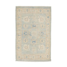 Weathered aqua blue 3x5 Oushak area rug with muted ivory and beige floral medallions and a distressed sand border.