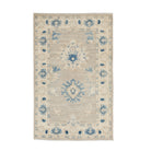 Traditional khaki 3x5 Oushak area rug with prominent blue and ivory geometric star medallions and a cream border.
